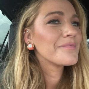 Blake Lively shares a casual selfie, showcasing her radiant smile and stylish earrings.